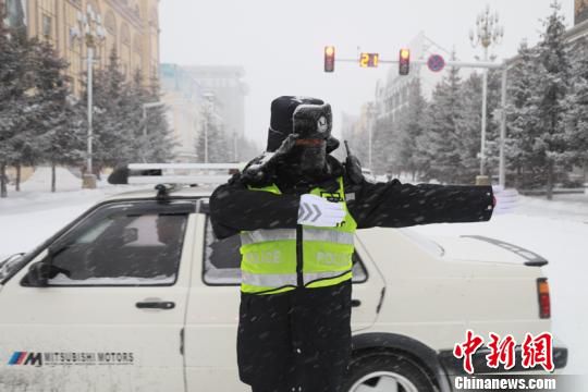 交警雪中疏导交通。(王景阳 摄)