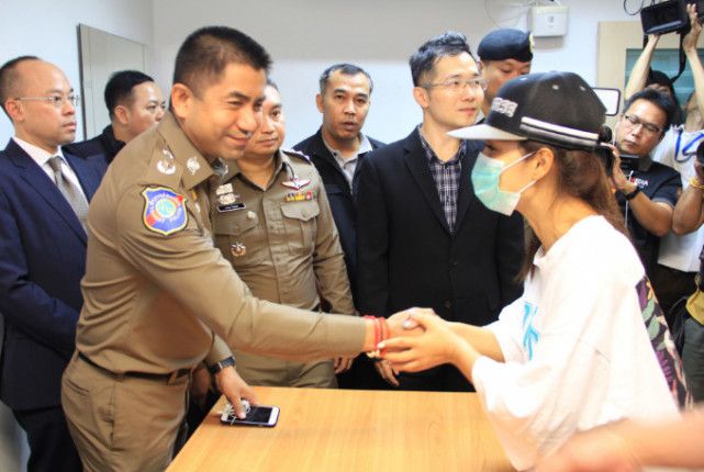 女事主与泰国警方握手致谢（泰国民族报）